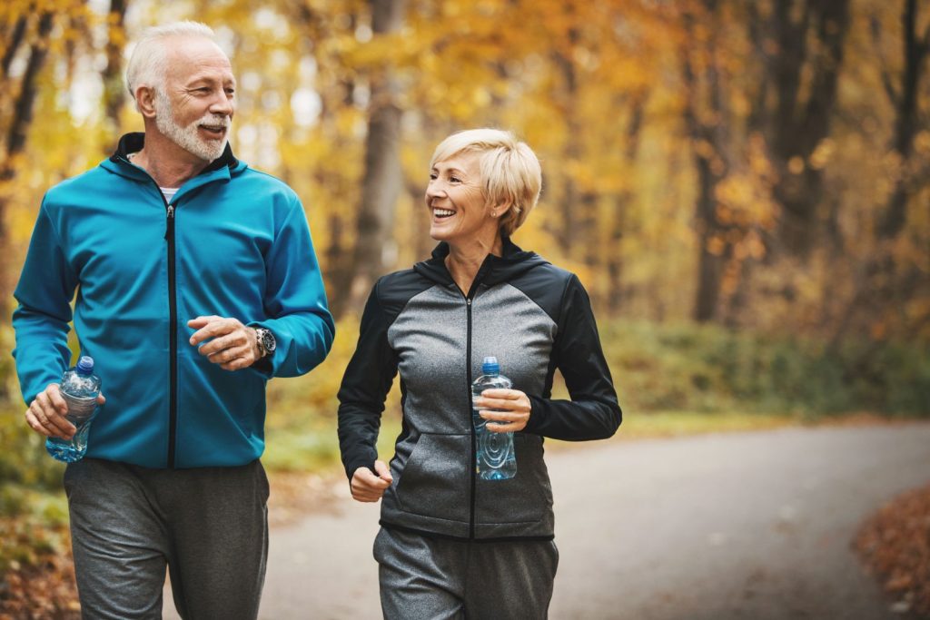 Active seniors jogging in Austin, highlighting healthy aging and Hormone Balance Therapy in Austin.